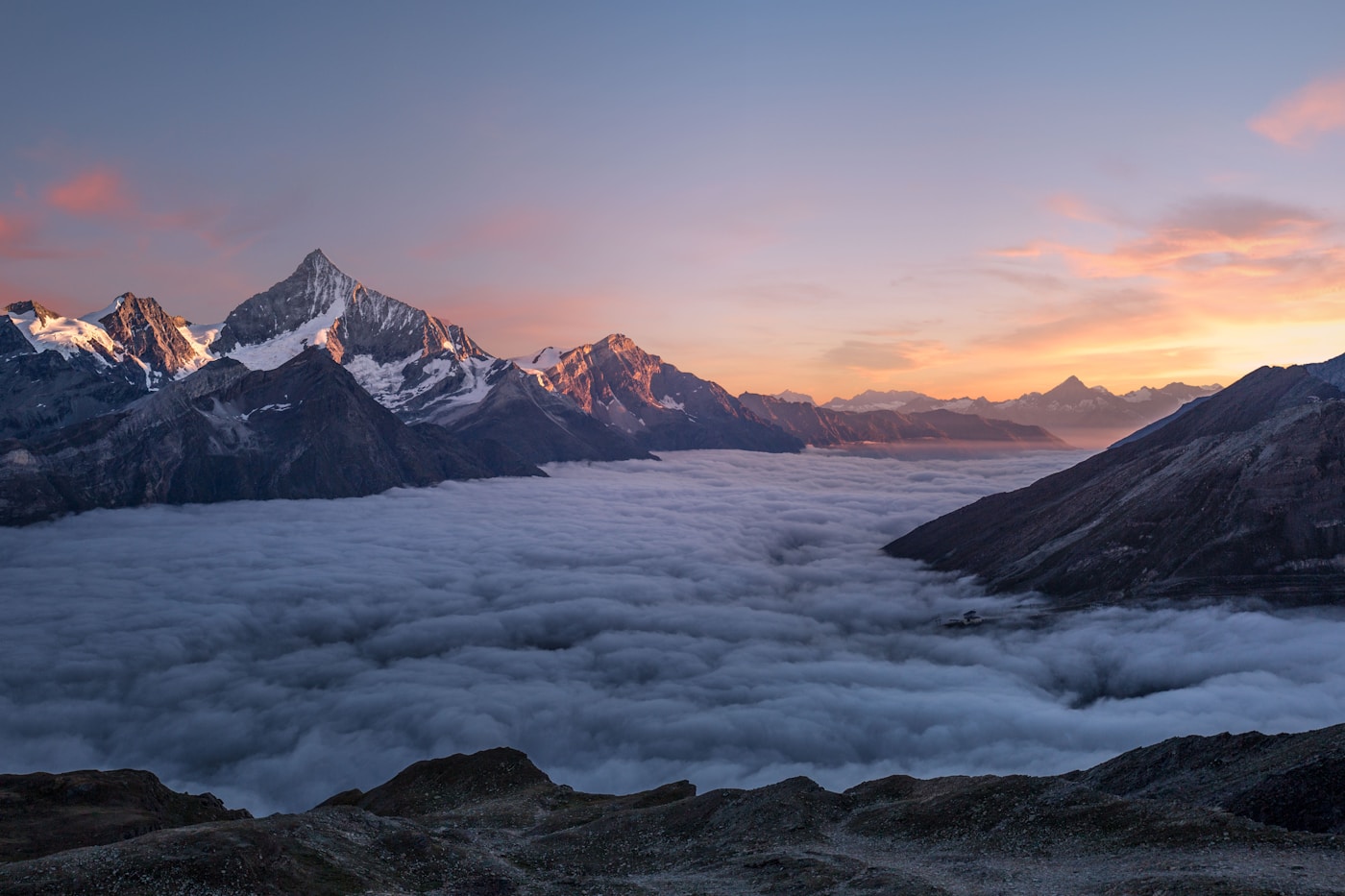 Panoramic view of a snowy ski resort mountain range